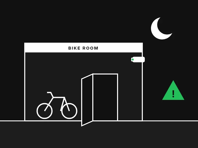 Night scene of a bike room with its door forced open and a green warning sign